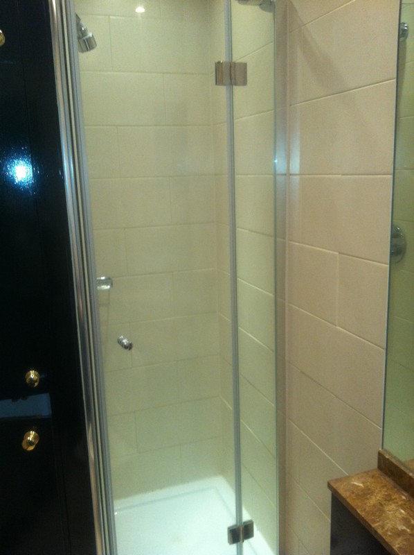 Frameless glass shower enclosure with chrome fittings in Grove Park