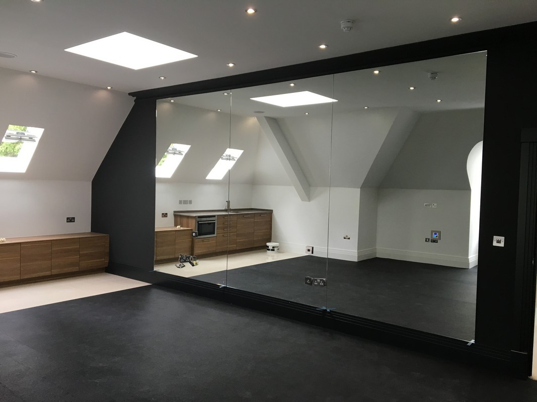 Frameless glass wall dividing loft conversion in Grove Park