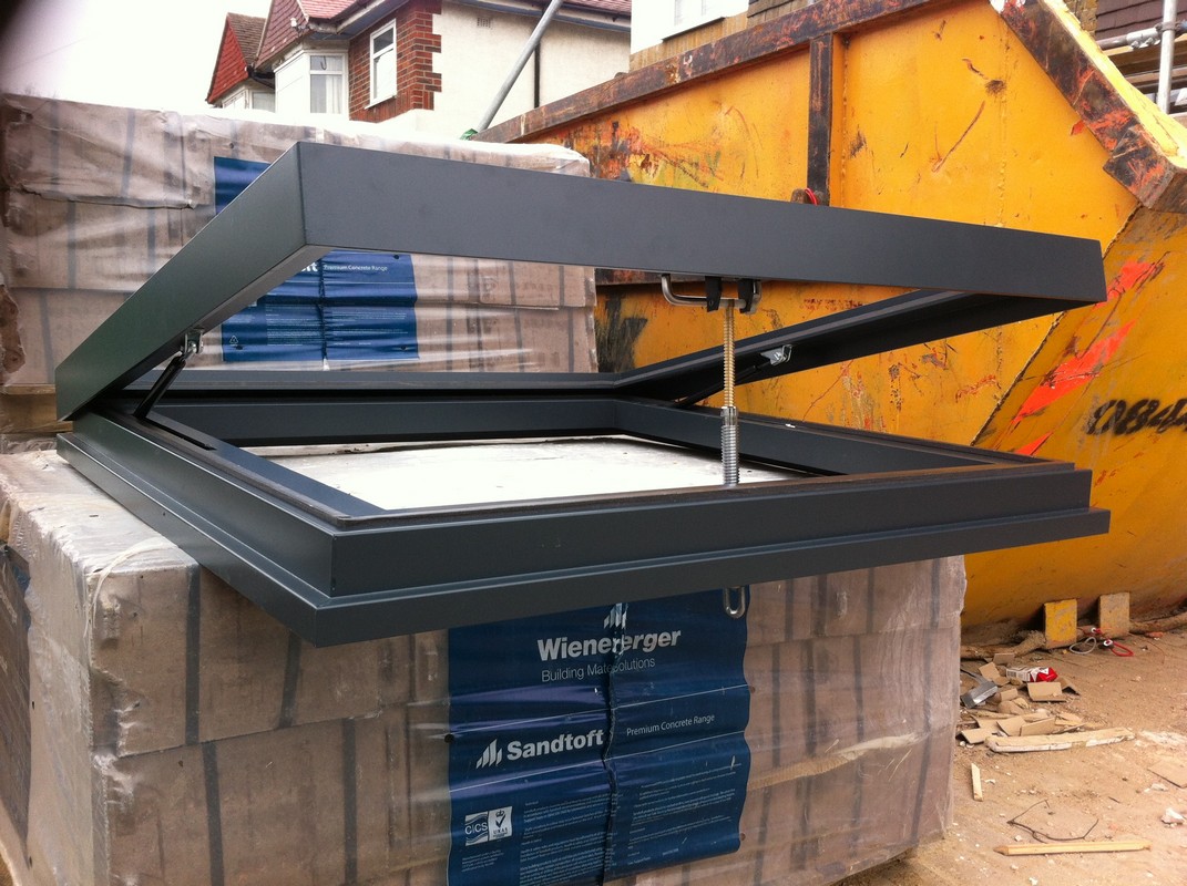 Opening flat roof skylight in anthracite grey installed in Grove Park